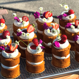 Vanilla cake with chocolate frosting, topped with fresh flowers